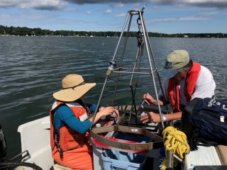 EPA scientists using the benthic sediment grab tool to collect samples from the Three Bays Estuary in summer of 2019.